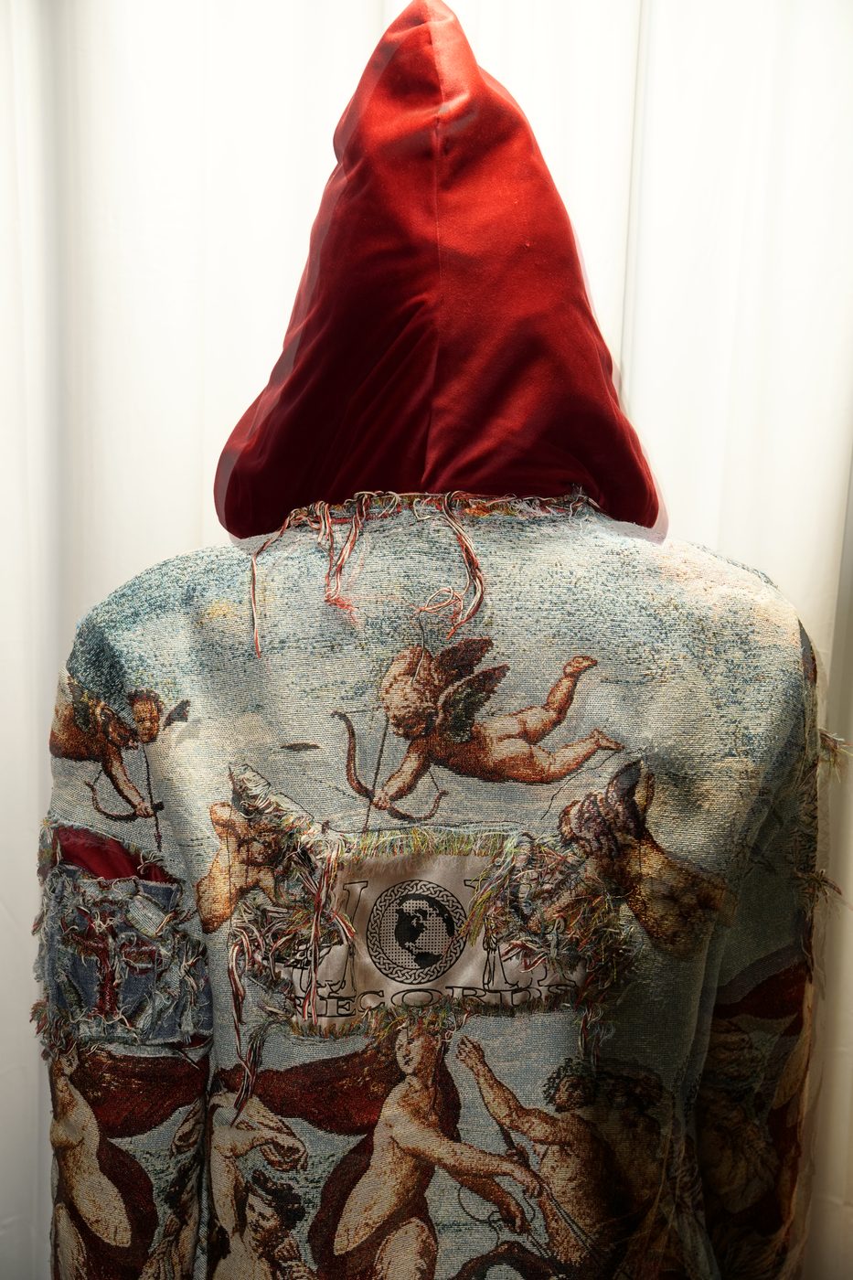 Macro detail of the woven Heaven or Hell Records label stitched into the tapestry jacket