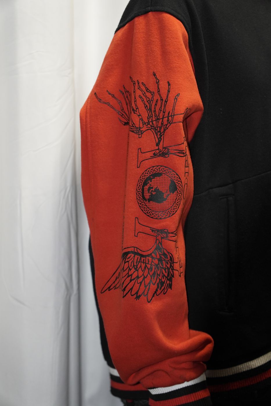 Orange and black varsity jacket with Heaven or Hell Records graphic